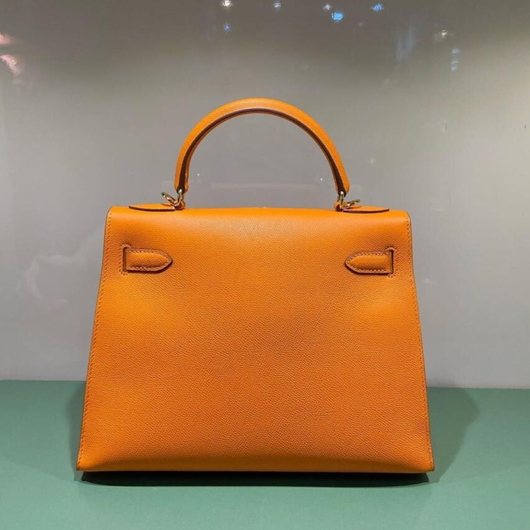 Hermès – Kelly 25 bag in orange with gold-colored hardware